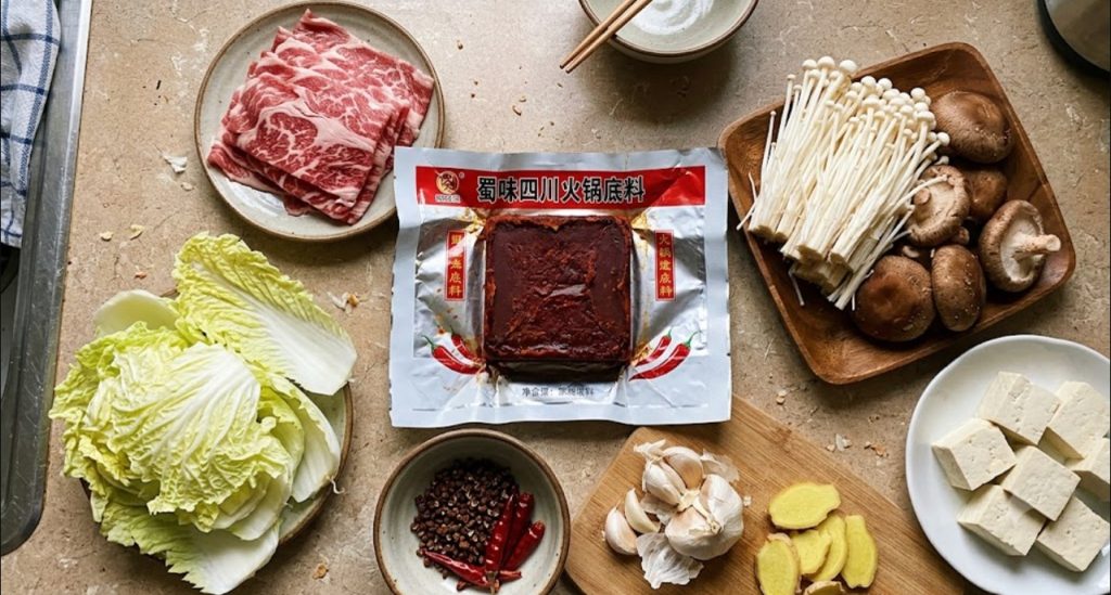 Ingredients for maocai: hot pot base, sliced meat, tofu, mushrooms and vegetables