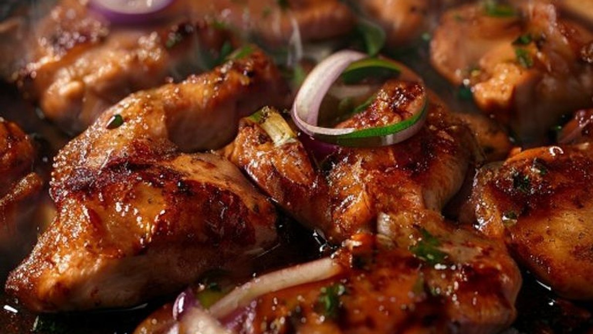 Close-up of chipotle chicken thighs searing in a cast iron skillet, demonstrating the precise cooking technique for deeply charred flavor and succulent texture.