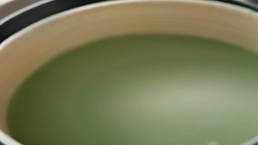 Salad spinner basket rotating inside outer bowl to remove water