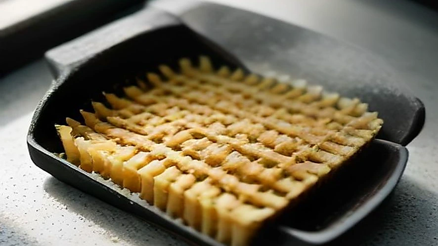scrub brush on grill grate and sponge on countertop