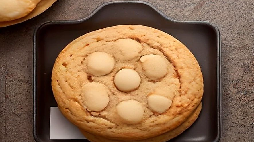 cookies on silicone baking mat and sticky candies on parchment paper