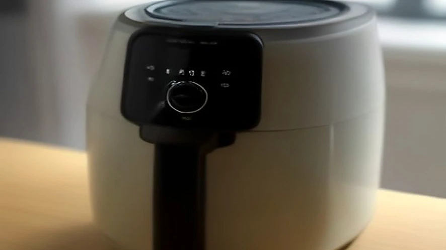 Compact air fryer with touchscreen controls on a kitchen countertop