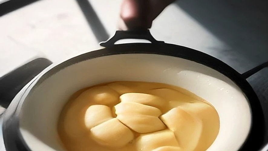 bread maker kneading paddle mixing dough inside the pan