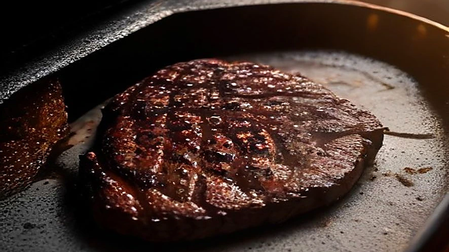 Thermocouple probe inserted into steak showing precise temperature measurement