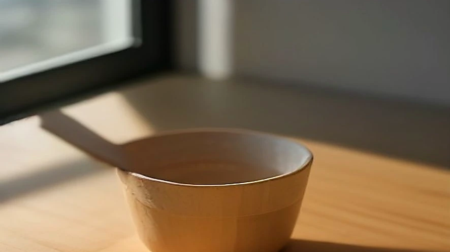 salt cellar with magnetic lid and wooden spoon on kitchen counter