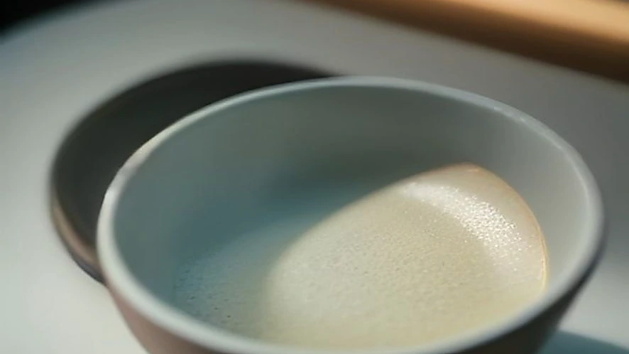 Digital kitchen scale showing zero after taring with a bowl and flour on top